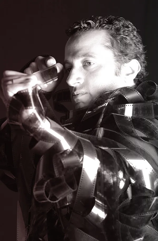 Waleed Nassif wrapped in strips of film, black and white