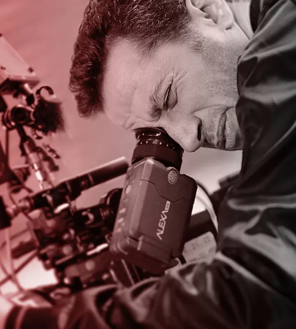 Waleed Nassif at an ARRI Alexa camera, red-toned black and white