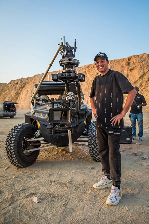 Waleed Nassif on a desert location beside a camera buggy